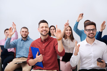 Wall Mural - People raising hands to ask questions at business training on white background