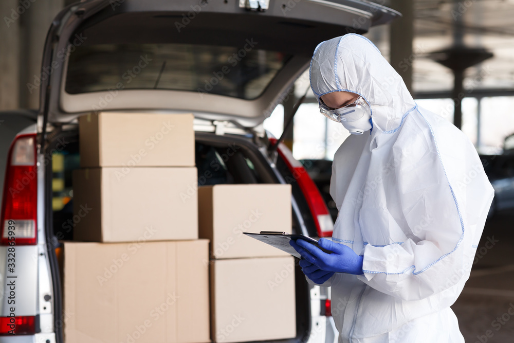 Danger business of trucking, delivering in virus protective suit - obrazy, fototapety, plakaty 