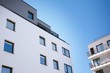 © Grand Warszawski - Modern european apartment building with balconies on a clear sunny day