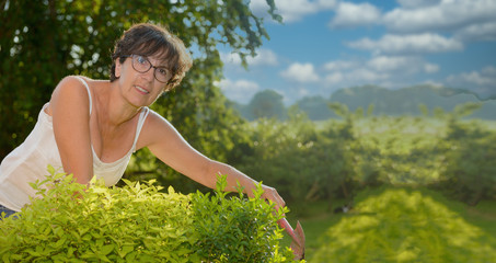 Wall Mural - Portrait of a middle-aged brunette woman with eyeglasses, outdoor