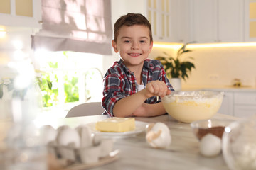 Poster - Cute little boy cooking dough in kitchen at home