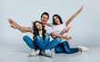 © My Ocean studio - Beautiful excited and the funny family team is posing and pointing in a white t-shirt while they isolated on white background in studio.