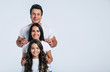 © My Ocean studio - Beautiful excited and the funny family team is posing and pointing in a white t-shirt while they isolated on white background in studio.