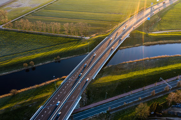 A viaduct bridge crossover a canal of highway A59 during sunrise near Waalwijk, Noord Brabant, Netherlands