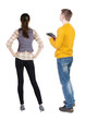 © ghoststone - Back view of couple in sweater with mobile phone.