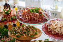 Delicious Snack, Appetizer On Party Or Picnic Time. Beautifully Decorated Catering Banquet Table With Cold Snacks, Salads, Cold Meats, Sliced Sausages. Variety Of Tasty Delicious Snacks.