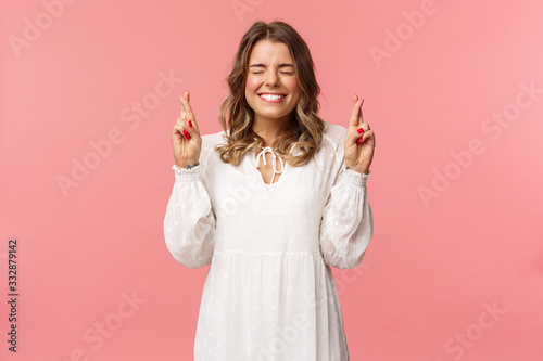 Fotografía Portrait of hopeful lucky cute blond girl in white dress praying, anticiapte mir