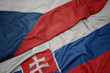 waving colorful flag of slovakia and national flag of czech republic.