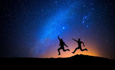 Canvas Print - two men jumping one night with stars
