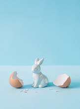 Eggshell With Bunny Rabbit. Creative Copy Space On Pastel Blue Background. Minimal Easter Holiday Concept.