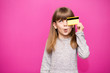 © Svetlana - Joyful little blonde shy face girl 6-7 years old hold credit bank card isolated on pink. Childhood lifestyle concept.