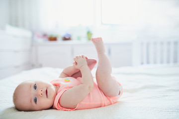 Cute baby girl lying on her back