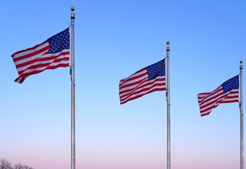 American flag of the United States of America  floating in the sky on a mast