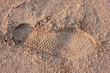 Imprint Of Shoes On Sand. Lonely Human Footprint On A Sandy Surface