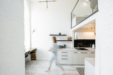 Interior View Of The Bright And Modern Kitchen With A Blurred In Motion Human Figure