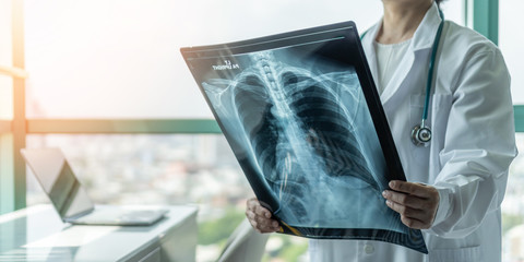 Wall Mural - Doctor diagnosing patient’s health on asthma, lung disease, COVID-19 or bone cancer illness with radiological chest x-ray film for medical healthcare hospital service