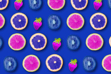 Summer Pattern With Juicy Ripe Fresh Slices Of Purple Grapefruit, Blue Orange And Purple Strawberry On A Blue Background