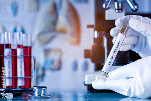 Fotomural Medical or scientist or doctor holding tube with nCoV Coronavirus vaccine for pr