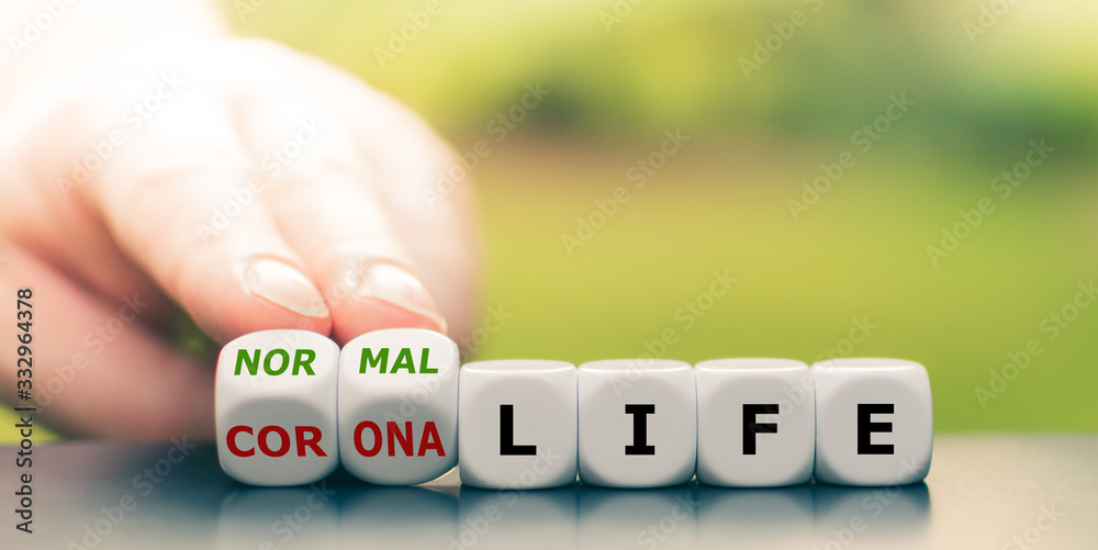 Back to normal. Hand turns dice and changes the expression "corona life" to "normal life". - obrazy, fototapety, plakaty 