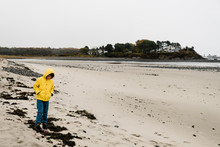 Stock Photo Of Boy With Yellow Coat On The Seaside On Maine On A Foggy Winter Day