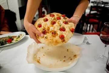 Wall Mural - Serving bread with cracklings and cherry tomatoes