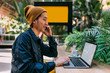 © MyMicrostock/Stocksy - Asian tourist working on laptop using the free wifi of the train station