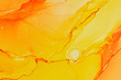 © Julie Rideout/Stocksy - Abstract alcohol ink design in orange and yellow