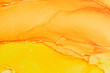 © Julie Rideout/Stocksy - Abstract alcohol ink design in orange and yellow