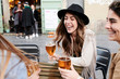 © Ivan Gener/Stocksy - Friends reunion in bar terrace with beers.