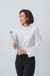 © Maki Company Limited/Stocksy - Modern asian business woman holding folder and standing.