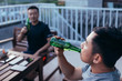 © MaaHoo Studio/Stocksy - Friends with beer bottles in yard