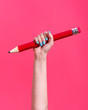 © CACTUS Creative Studio/Stocksy - Hand holding a big pencil.