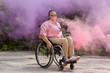 © Clique Images/Stocksy - Cheerful Young Disabled Woman In Smoke