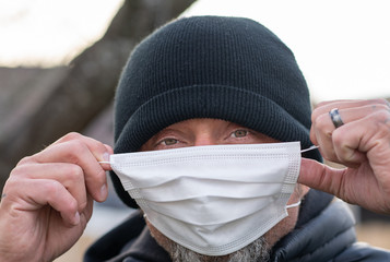 Wall Mural - man wearing protective breathing mask to avoid germs