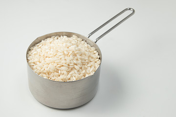 Wall Mural - Arborio Rice in a measuring cup