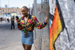 © Mauro Grigollo Photographer/Stocksy - Portrait of a afro woman using the mobile phone on the street