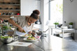 © Garage Island Crew/Stocksy - Woman cooking during a kitchen class