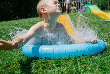 Young Boy On Summer Water Slide