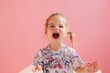 © Liliya Rodnikova/Stocksy - Funny little girl studio portrait on pink background