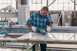 © Raymond Forbes LLC/Stocksy - Latino Man Working in Industrial Facility