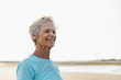 © Raymond Forbes LLC/Stocksy - Portrait of Healthy Senior Woman Walking on Beach