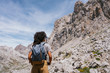 © Kike Arnaiz/Stocksy - rear view of a curly hair woman hiking the europe peaks.