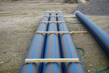 Ceramic sewer pipe stacked on construction site