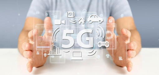 Poster - Businessman holding a 5G connection with data surrounding - 3d rendering