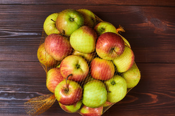 Poster - Packing apples in a grid on a wooden background.