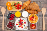 Fototapeta Kuchnia - Breakfast Served in the morning with Fruit Yogurt, Butter croissant and corn flakes Whole grains and raisins with milk in cups and Strawberry, Raspberry, Kiwi, Fresh Orange Juice on the breakfast