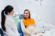 © Andrii - A professional dentist treats and examines the oral cavity of a pregnant girl in a modern dental office. Dentistry