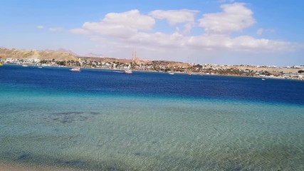 Wall Mural - Panorama of the Red Sea in Sharm el-Maya bay and the Old Market on the opposite shore in Sharm El Sheikh (Egypt) (16). Amazing seascape of an exotic tropical resort with turquoise-blue water and ships