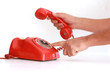 © Alejandro Mendez - Hands making a call in vintage red telephone