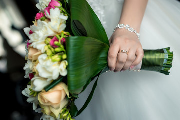 Wall Mural - Beautiful wedding bouquet in the hand of the bride close-up